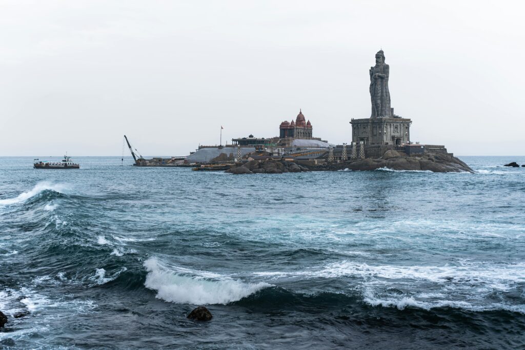 View of Vivekananda Rock Memorial and Thiruvalluvar Statue on a rocky islet in Kanyakumari.